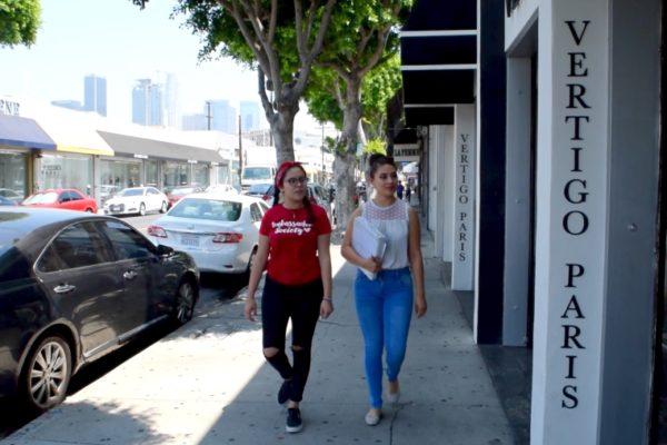 Two woman walking through the Los Angeles Fashion District